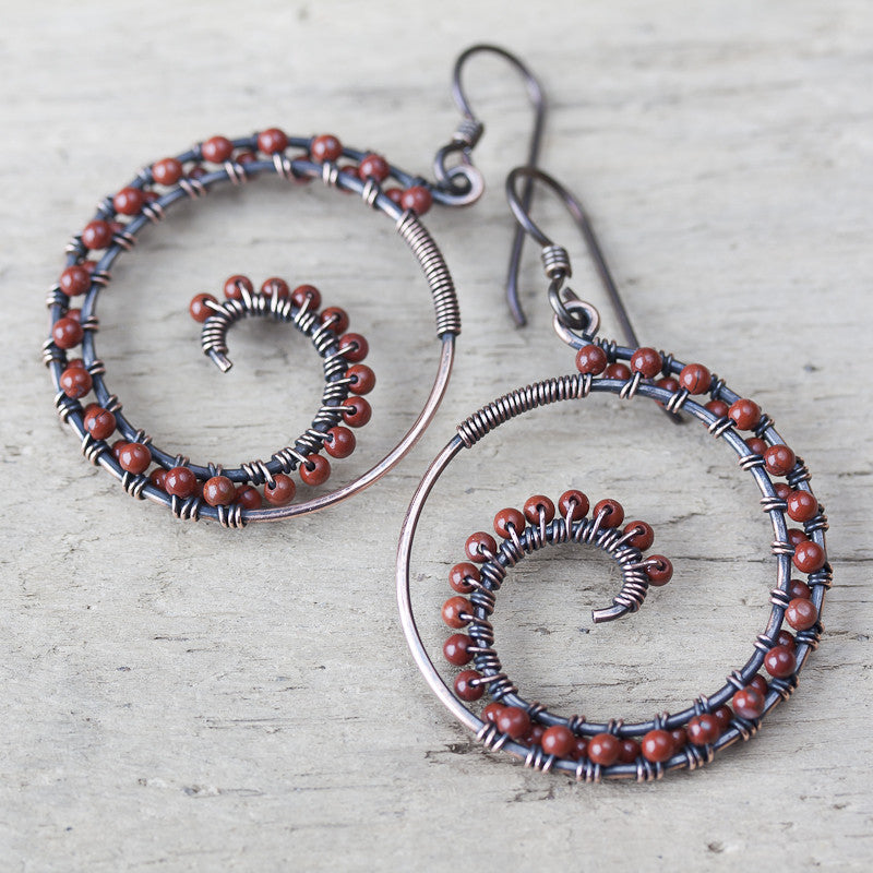 Dark brown oxidized copper wire wrapped spiral hoop earrings with red jasper beads - jewelry by CookOnStrike